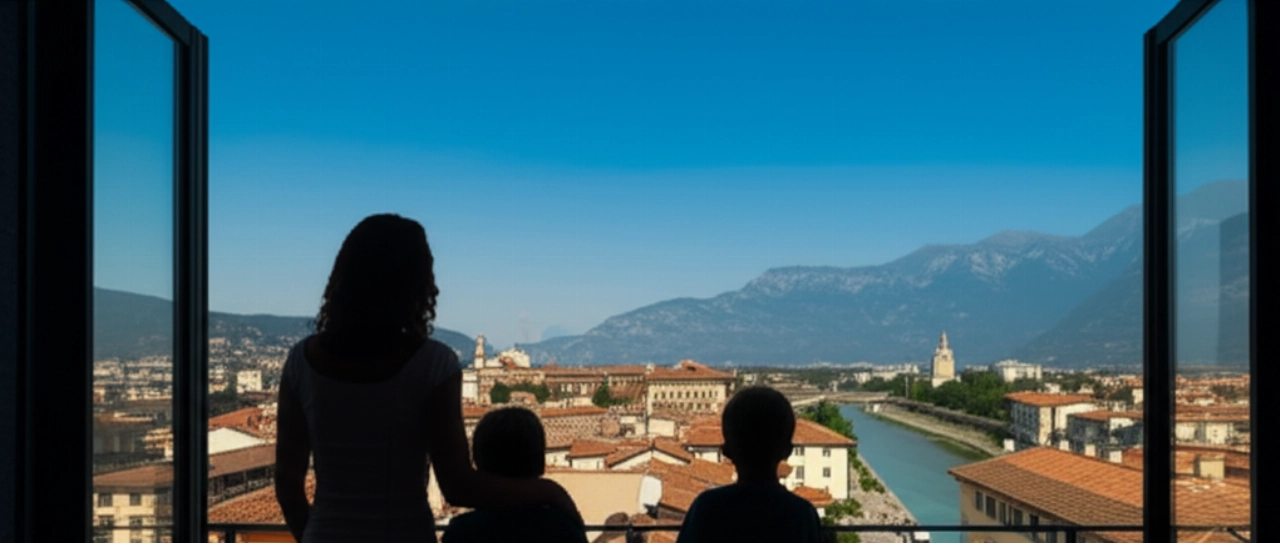 Familia caucásica admirando la vista panorámica de Belluno y los Dolomitas desde el balcón de su nuevo hogar, con un camión de mudanzas visible en la calle.