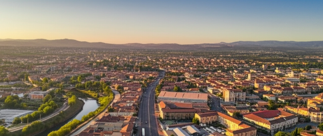 Vista aerea iperrealistica di Terni al tramonto con un camion dei traslochi su una strada.